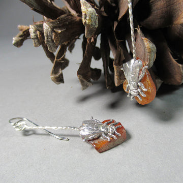 Ann Fillmore artwork 'Honeybee Pointing Down on Raw Amber Earrings' at Gallery78 Fredericton, New Brunswick